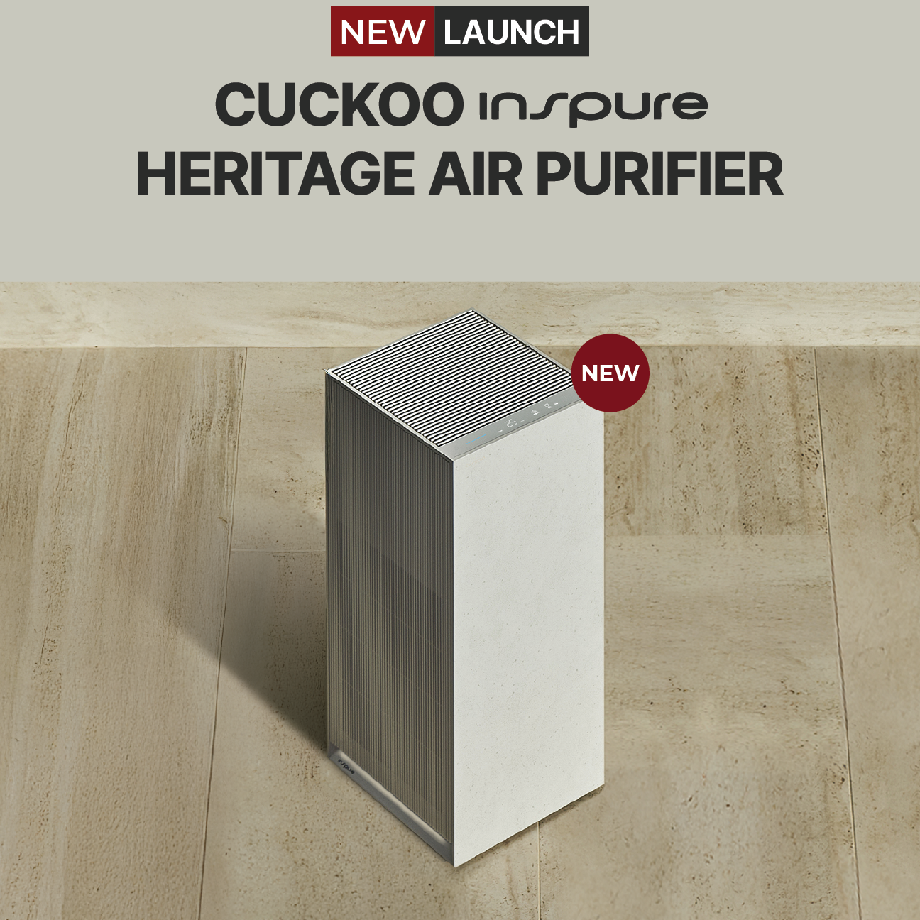 A sleek, white and silver Cuckoo Inspure Heritage Air Purifier standing on a tiled floor, announced as a new launch.